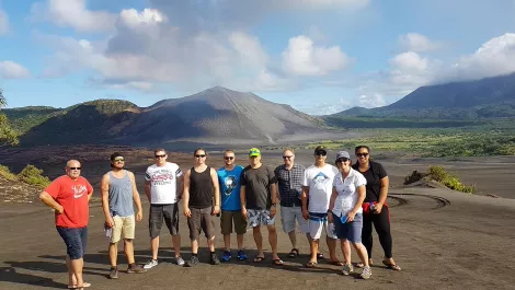 Group photo with mt yasur in the back ground